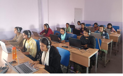 Learners working on computers in a training classroom