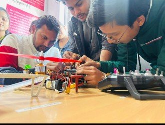 Learners assembling an electronics project at a workbench