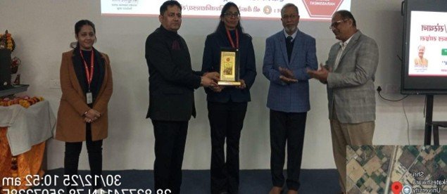 XETA trainer receiving an award with event organizers