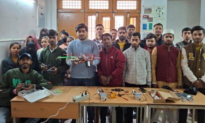 Learners working with electronics and robotics equipment in a lab