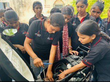 Learners practicing automotive repair in a workshop