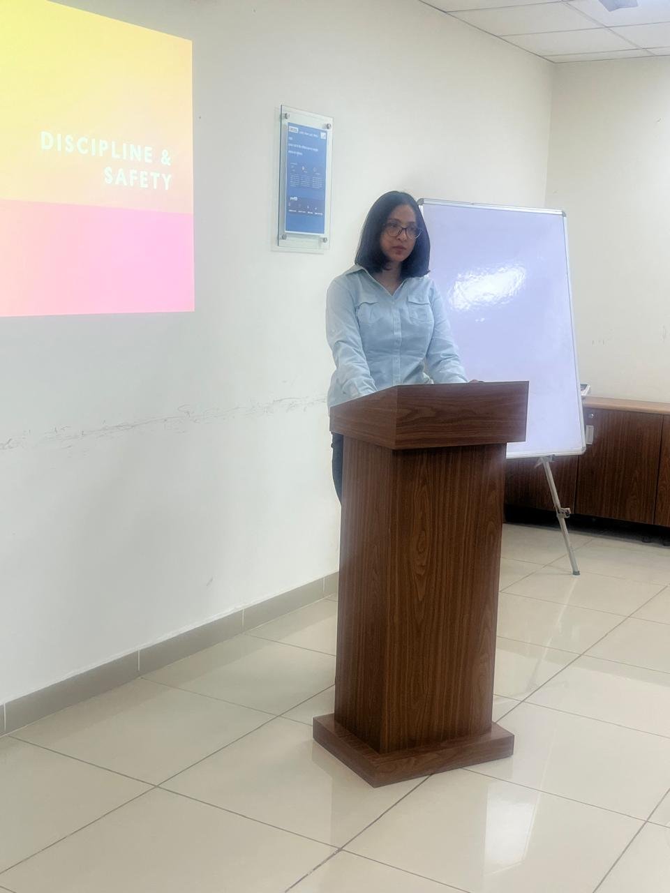 Priyanka presenting at a classroom podium